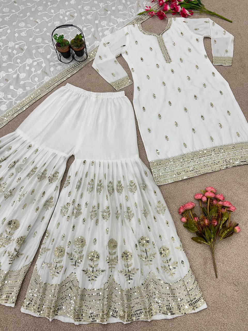 "Embrace elegance with our exquisite Chinnon silk top, plazo, and dupatta set - where tradition meets opulence in every thread."